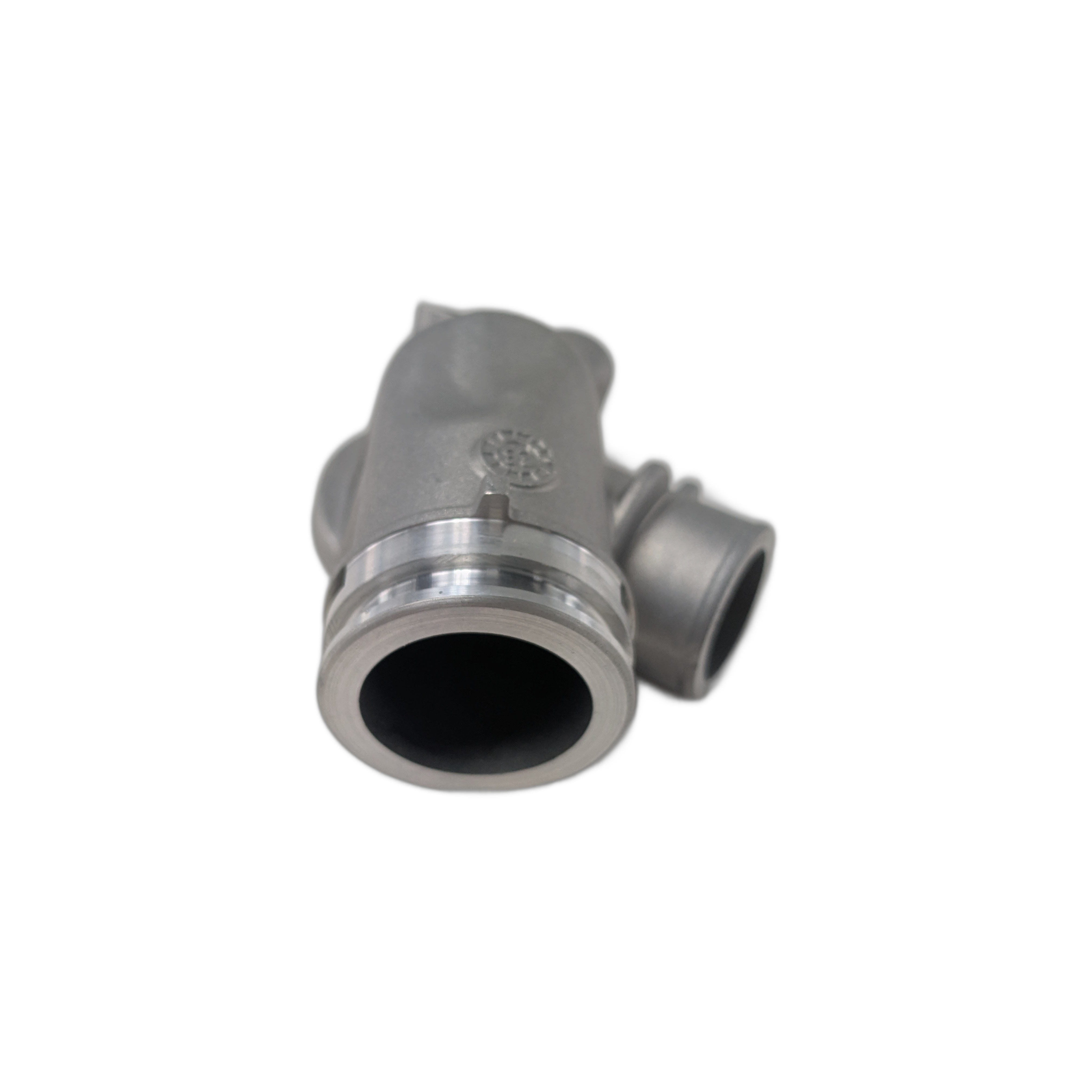 Matte gray metal motorcycle thermostat housing with cylindrical openings and a mounting flange.