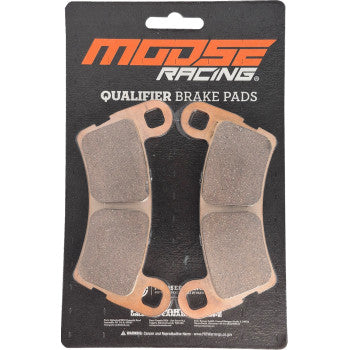 Set of two brown brake pads with copper-colored backing plates on black Moose Racing branded card.