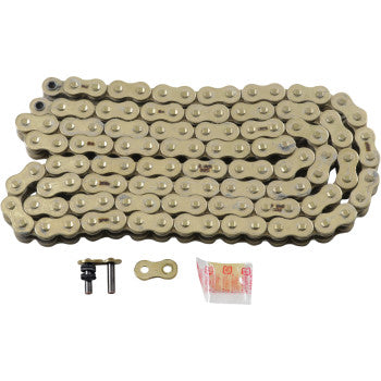 The 520 Max Z Drive Chain 130 Links Gold by RK is coiled with its connecting link, two pins, and grease packet in front. Engineered for top performance on high-horsepower street bikes, all displayed on a white background.