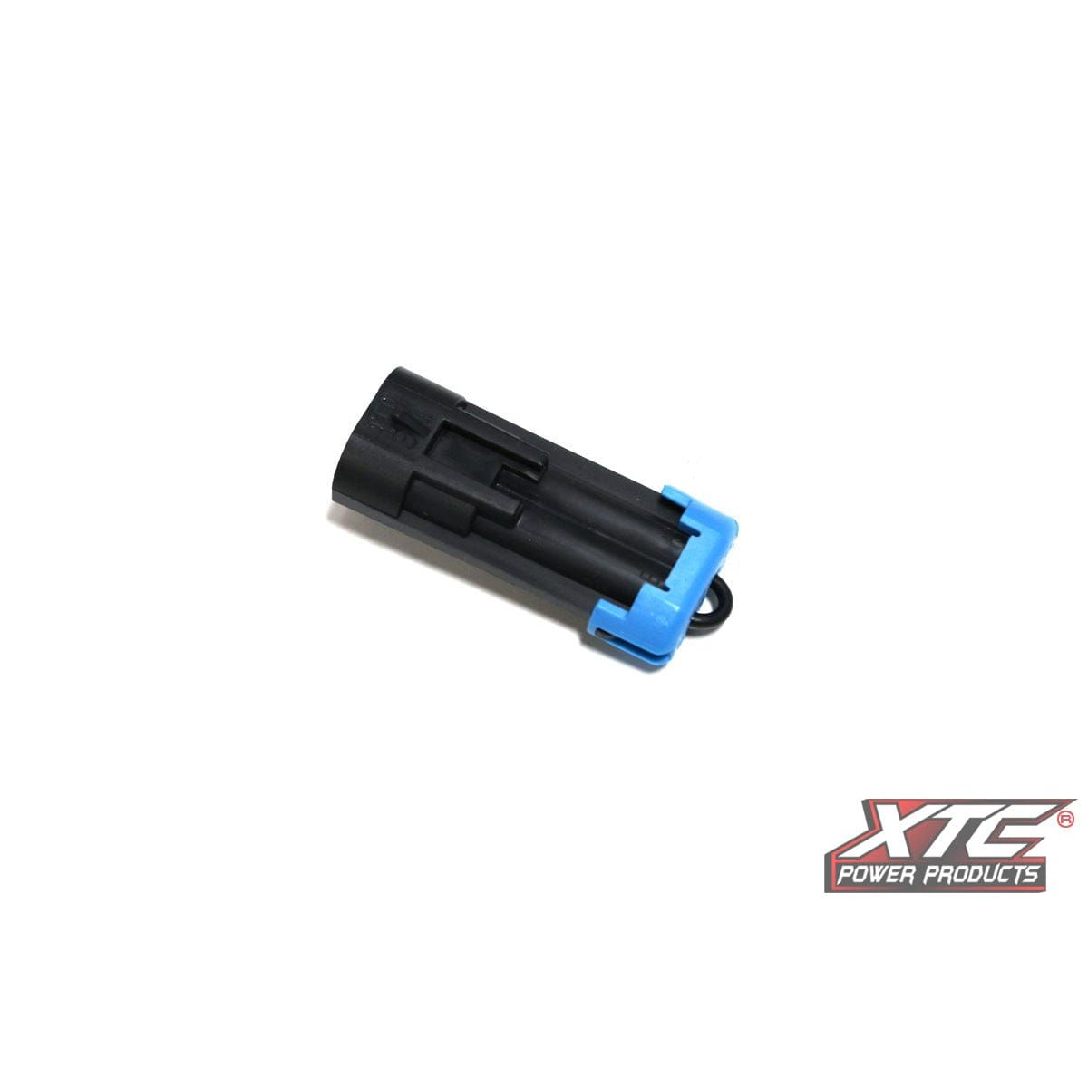 A black Plug N Play Seat Belt Pol connector by XTC Power with a blue clip, shown on a white background. The XTC Power Products logo appears in the bottom right corner.