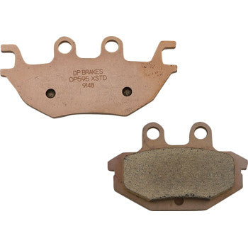 Two Kawasaki Sintered Brake Pads by DP Brakes, one with DP BRAKES DPS95 XSTD 9148 on the plain side and one showing the friction surface; both have holes and tabs for mounting on ATV brakes.