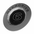 Round silver motorcycle cam cover with black center displaying large stylized number 6 and "Overdrive" text around edge.