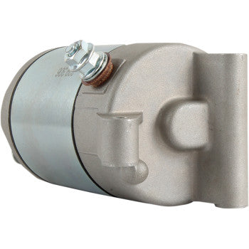 A close-up view of the Polaris Starter Motor by Parts Unlimited, showcasing its cylindrical silver body, insulated armature, mounting bolts, and multiple connection points.
