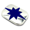 Silver rectangular metal badge with raised blue eight-point Polaris star design in center.
