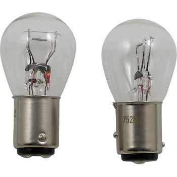 Two clear Miniature Bulb 7528s by Peak Lighting with metallic bases stand upright on a white background. Their filaments and inner parts are visible through the glass, showcasing OE-quality construction.