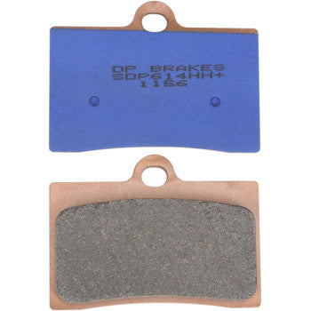 A pair of Sintered Brake Pads by Dp Brakes, each rectangular with a top central hole; one pad displays blue backing with text, the other shows a metallic friction surface and integrated ceramic heat shield.