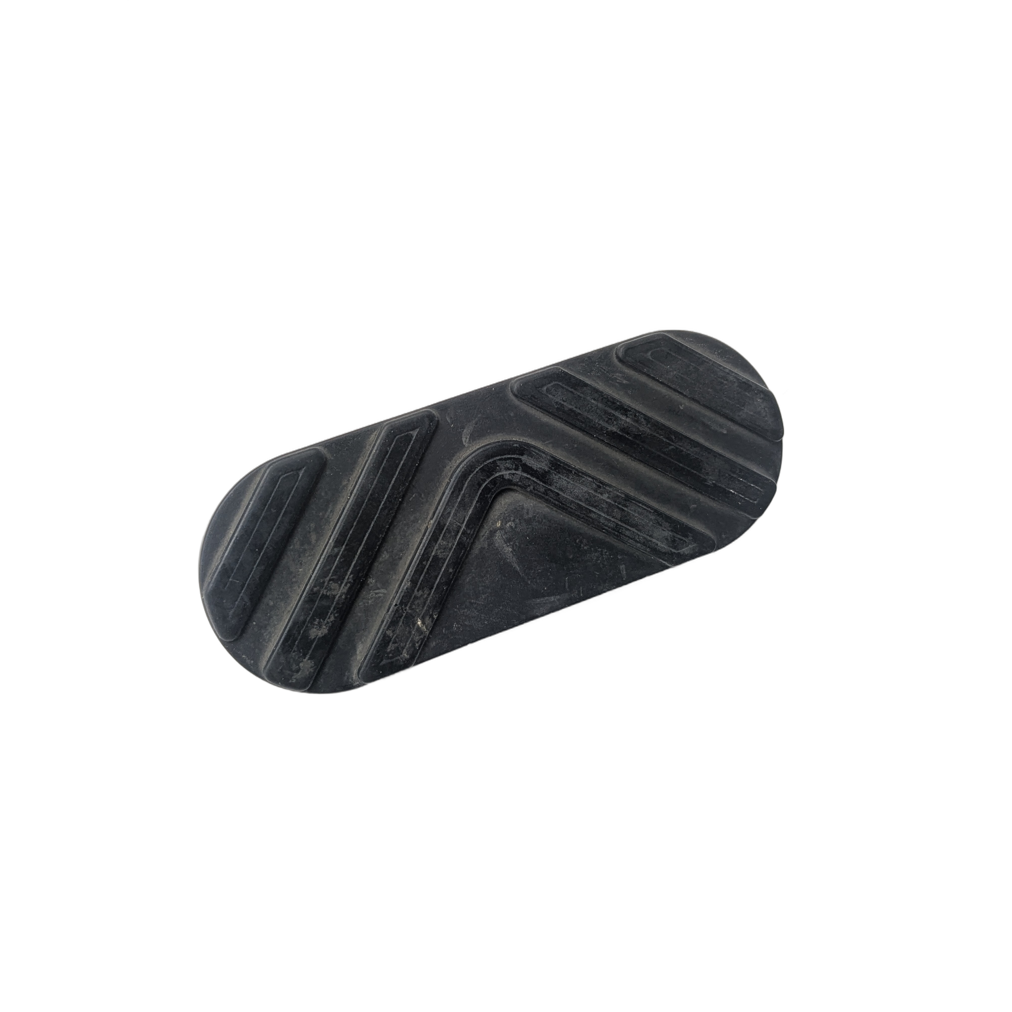 The Floorboard Pad by Polaris is a black, oval-shaped rubber pad with raised diagonal and curved grooves, designed as an OEM part for Victory motorcycles. Photographed on a white background.