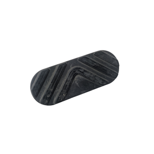 The Floorboard Pad by Polaris is a black, oval-shaped rubber pad with raised diagonal and curved grooves, designed as an OEM part for Victory motorcycles. Photographed on a white background.