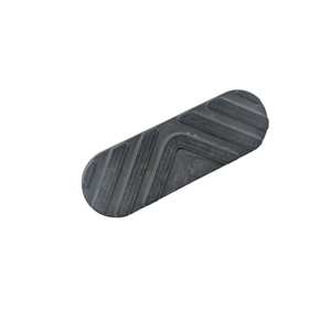 A black, oval rubber pad with diagonal grooves on a white background. The Floorboard Pad by Polaris is ideal as Pad F'Board #3 for OEM Victory Polaris—perfect for those seeking quality Victory motorcycle parts.