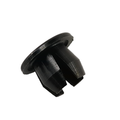 Black plastic master cylinder hole plug with a round flat flange and slotted prongs.