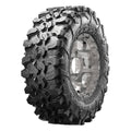 Black off-road tire with aggressive deep tread pattern mounted on silver metal wheel rim.