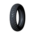 Black rear motorcycle tire with deep tread pattern for enhanced grip and durability.