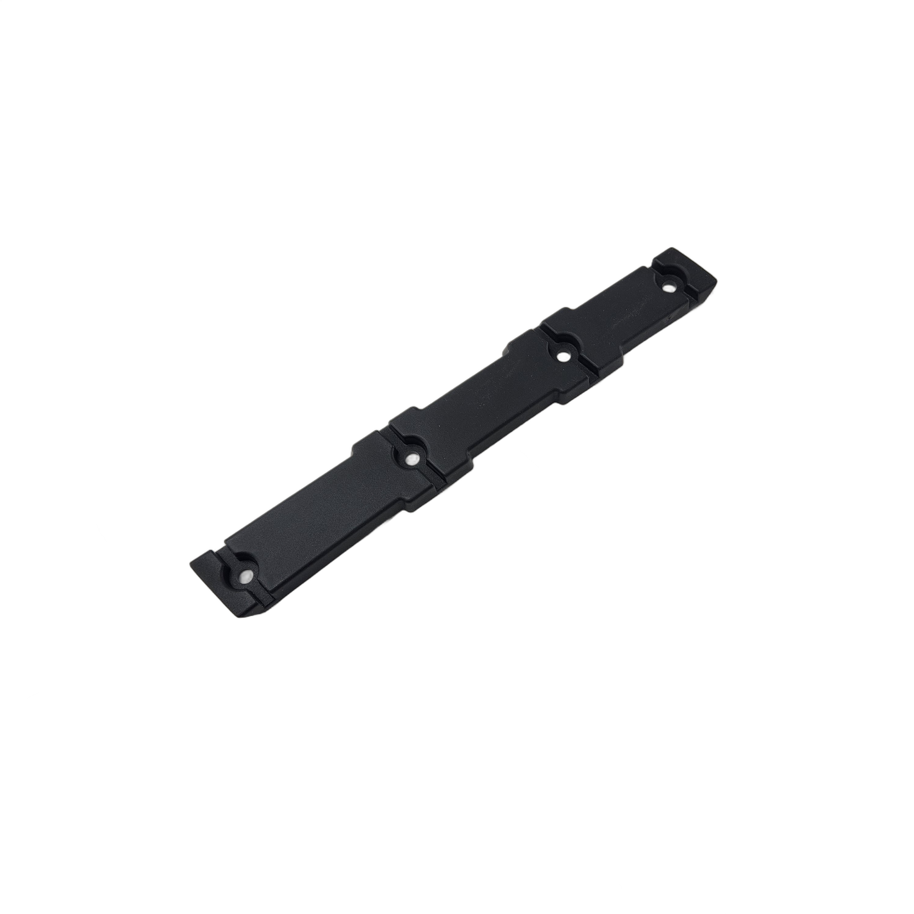 A black, rectangular Tie Down Rack Bracket Right Glo by Polaris is shown with four screw holes, slight ridges, and rounded ends for secure mounting. Designed as a Polaris UTV part, it appears on a white background.