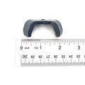 Small black plastic button cover with a U-shaped design, placed next to a ruler for scale.