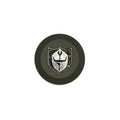 Black circular center wheel cap with silver shield emblem featuring a stylized knight helmet design.
