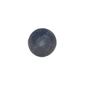 Round black metal clutch button with smooth flat surface and slight wear marks.