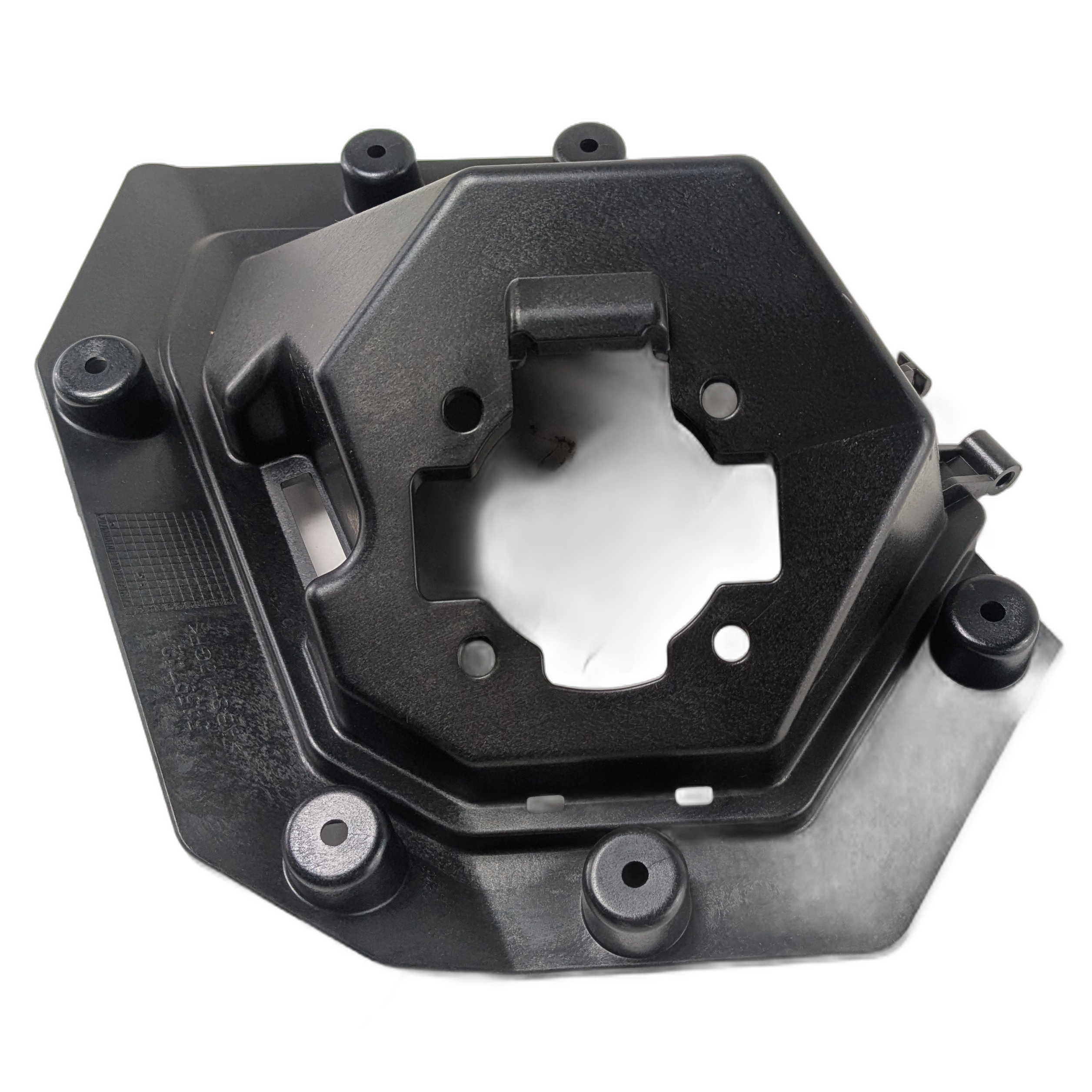 Black plastic charge port inner housing with a hexagonal central opening and multiple mounting points.