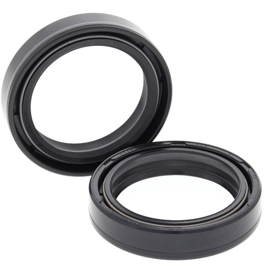 Black rubber fork seal kit with circular design and grooved edges, two pieces.