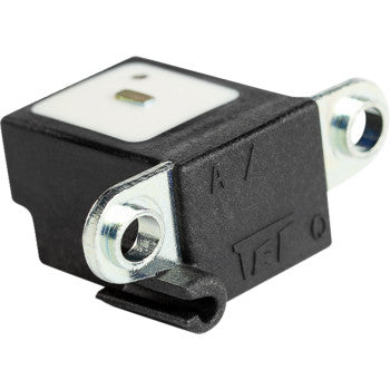 Black rectangular Honda trigger coil with metal mounting brackets and a white top plate with a small central sensor area.