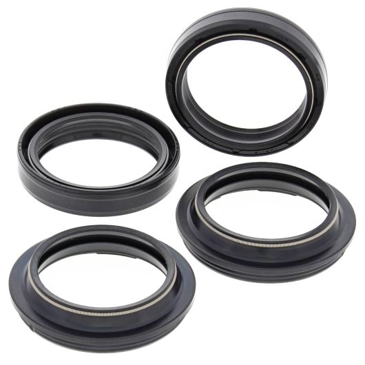 Set of four black rubber fork and dust seals with metal-reinforced edges for motorcycle suspension maintenance.