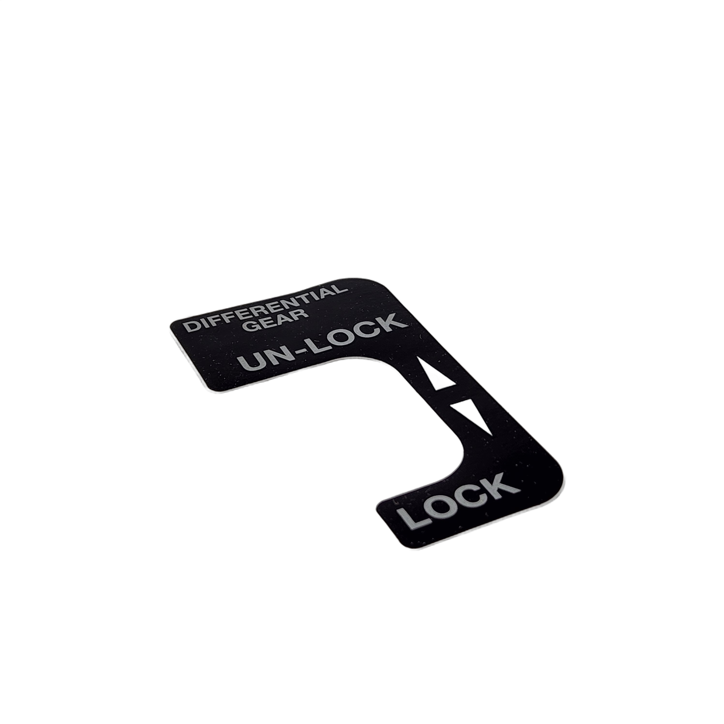 Black rectangular decal with white text and arrows indicating differential gear lock and unlock directions.