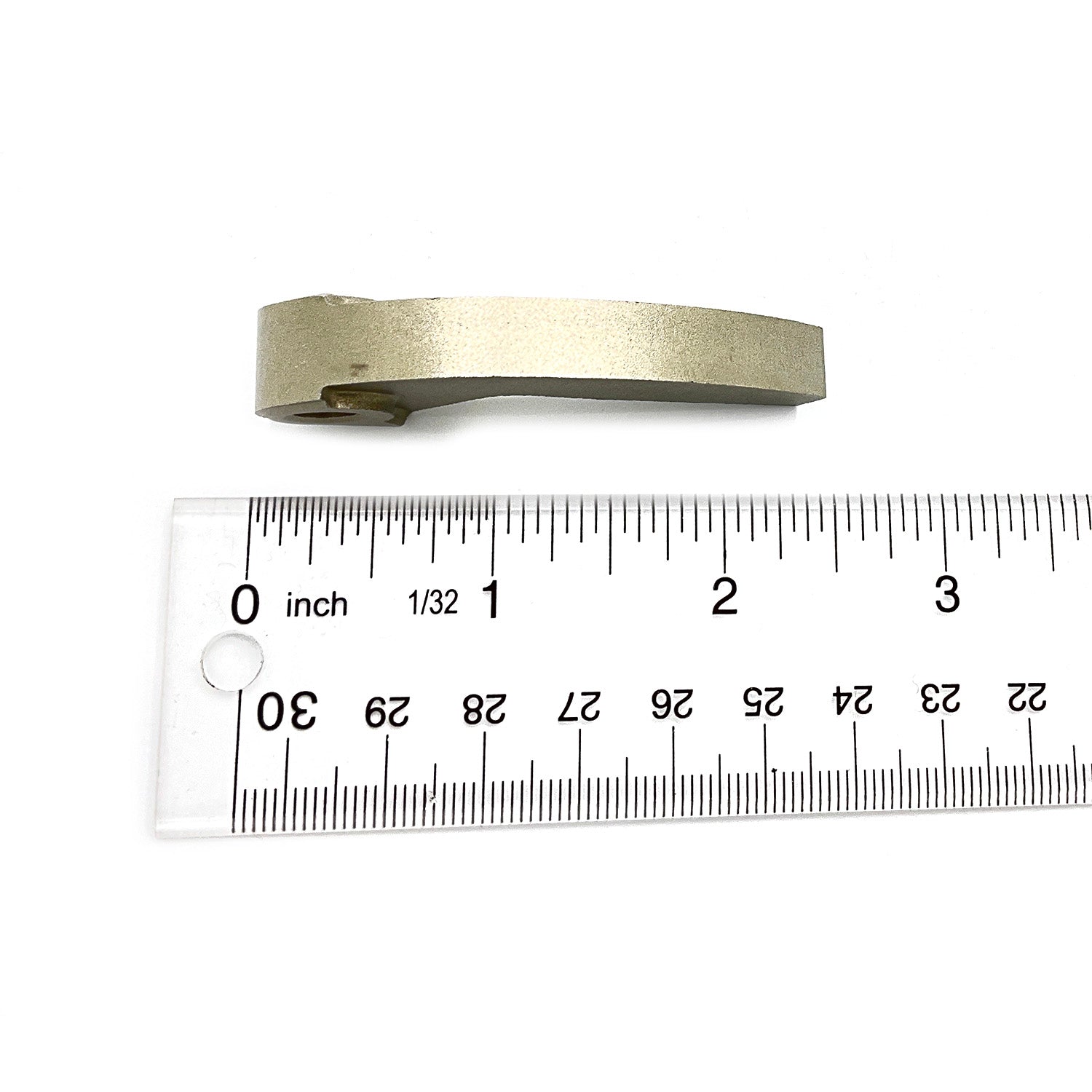 Curved metallic clutch shift weight about 2.5 inches long placed above a clear ruler.