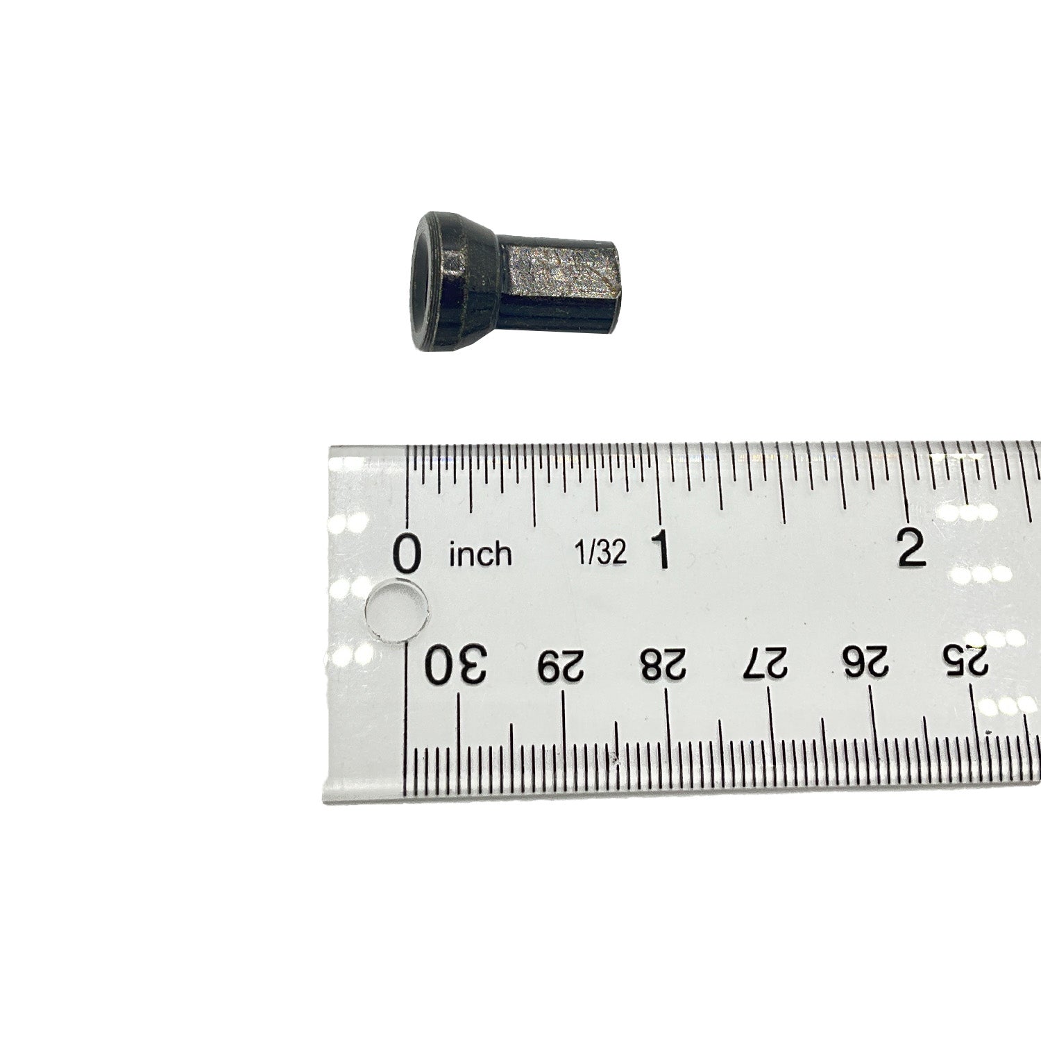 Black threaded cast anchor wedge with hexagonal head next to a metal ruler showing size under 1 inch.
