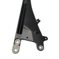 Black cast metal motorcycle frame backbone with wrinkle finish and mounting holes.