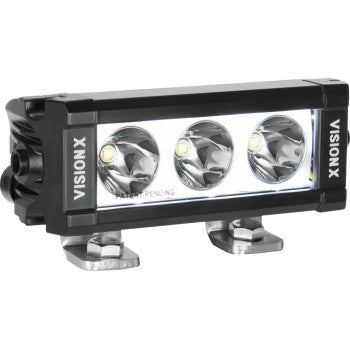 The Light Bar XPL 6" LED Clear Lens by Vision X features three round CREE LED bulbs in an ultra-slim rectangular housing with two metal brackets, ideal for off-road or automotive use.