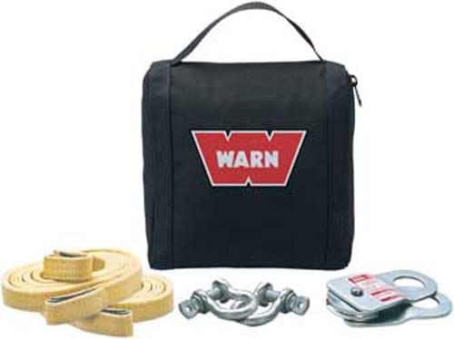 The ATV Light Winch Duty Accessory Kit by Warn includes a black carrying case, yellow tow strap, two metal shackles, silver snatch block, and durable tree trunk protector arranged in front of the case.