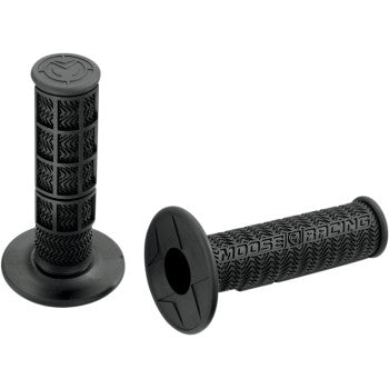 Two black Flange Style Stealth MX Grips by Moose Offroad feature textured, high-traction patterns and wide round flanges. “MOOSE RACING” is embossed on the side. One grip stands upright, the other lies down. Made in USA.