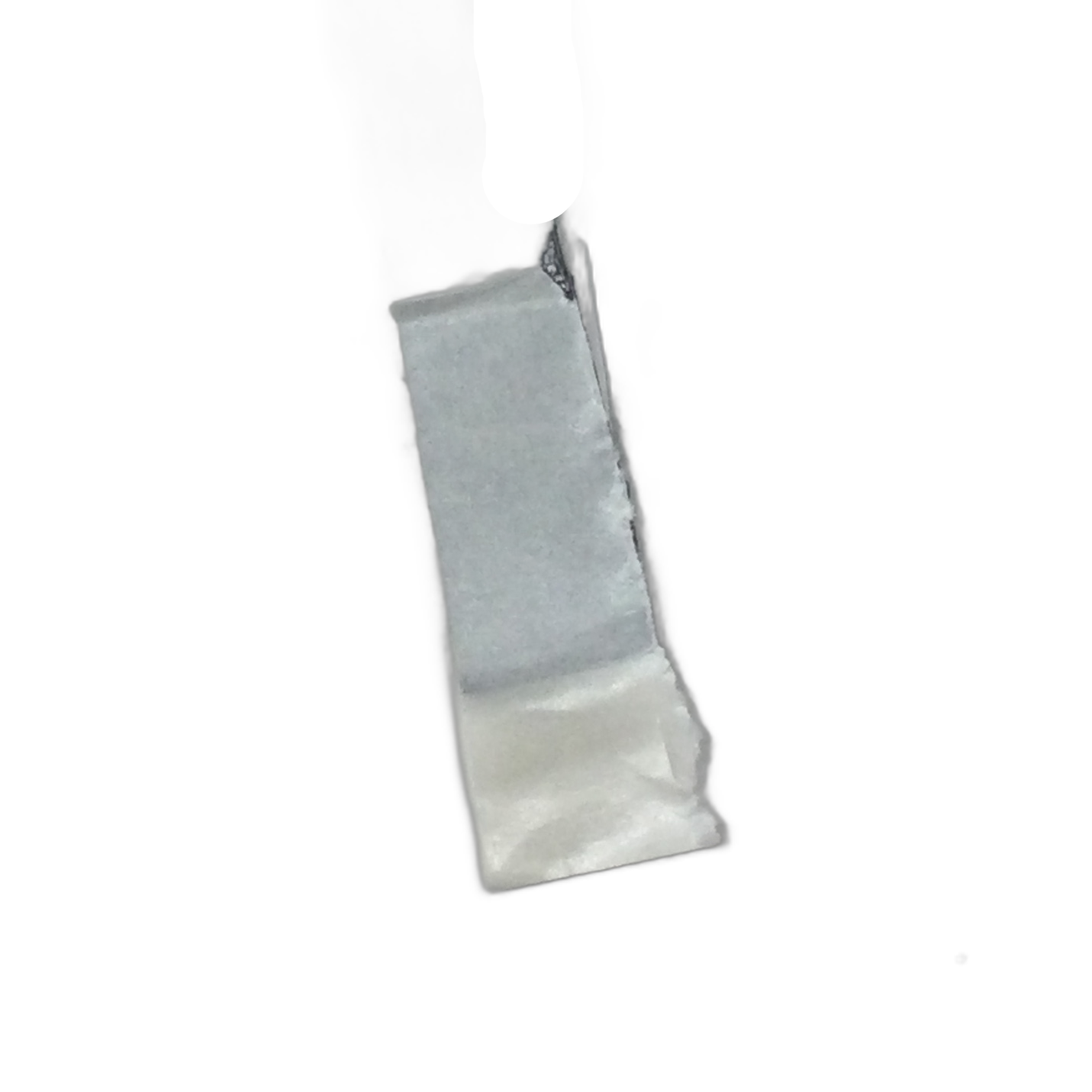 A rectangular piece of gray duct tape, like the Vhb-13Mm 5952 75Mm 30Mm Tail by Polaris used for Indian motorcycle parts, is stuck to a white surface with one corner wrinkled and the lower edge slightly lifted.