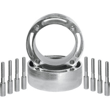 Two metallic circular Polaris Wheel Spacer Easy Fit 2.5 4/156 components by Dura Blue, positioned upright and flat, are flanked by six cylindrical metal pins on each side—all arranged on a white background.