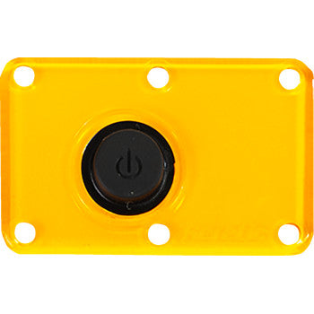 The Lens Dome Light Amber by Heretic is a rectangular yellow replacement lens with four corner holes and a central black power button featuring a power symbol.