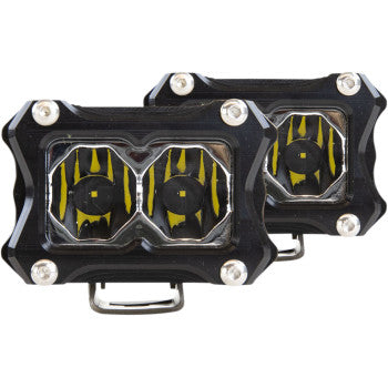 Two rectangular black Spotlight 2" Clear Lens by Heretic lights with silver corner screws and stainless steel mounts; each features two round yellow and black patterned lenses in the center.
