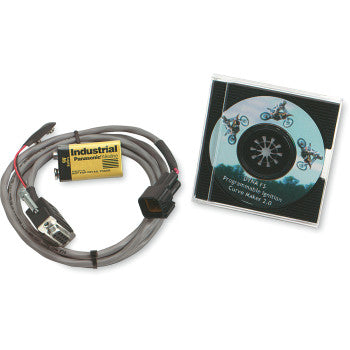 The Programming Kit by Dynatek includes a programming cable with connectors, a yellow Industrial battery, and an ignition reprogramming software CD case showing a stunt motorcyclist on the cover.