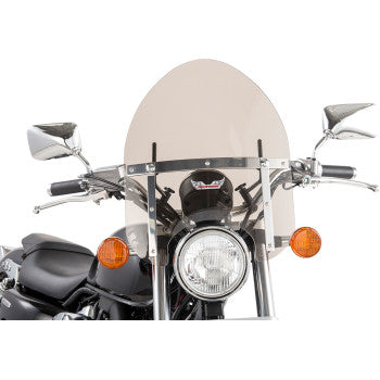A motorcycle with a Police Windshield - Tinted by Slipstreamer, chrome handlebars secured by a universal clamp, side mirrors, a round headlight, and two orange turn signals on either side of the headlight.