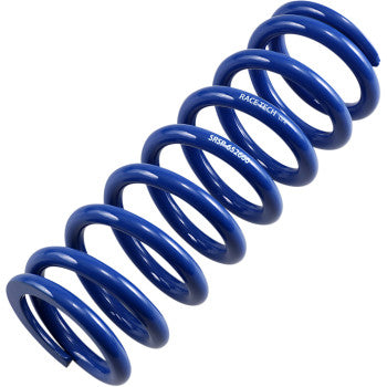A close-up of the Shock Spring Rear Blue Race Series by Race Tech (spring rate 336 lb/in), shows its chrome silicon wire coils, angled diagonally on a white background. Printed text highlights its outstanding stiffness-to-mass ratio.