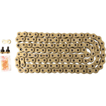 The 520 XRE Drive Chain 120 Links Gold by RK is coiled on a white background, shown with a connecting master link, two black chain pins, and a small packet of orange lubricant.