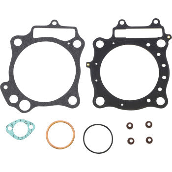 The Honda Top End Gasket Set by Prox includes two large black gaskets with multiple holes, a small green gasket, a copper ring, a black O-ring, and four small brown washers shown on a white background.