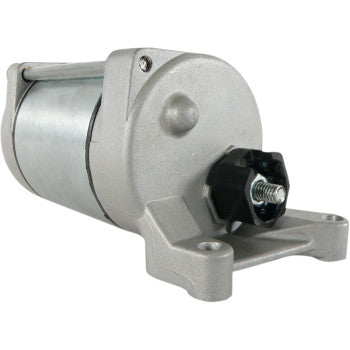 A close-up of the Starter Motor by Parts Unlimited, featuring a metallic cylindrical body, copper bushings, a black adjustment knob, and a base mounting bracket with screw holes.