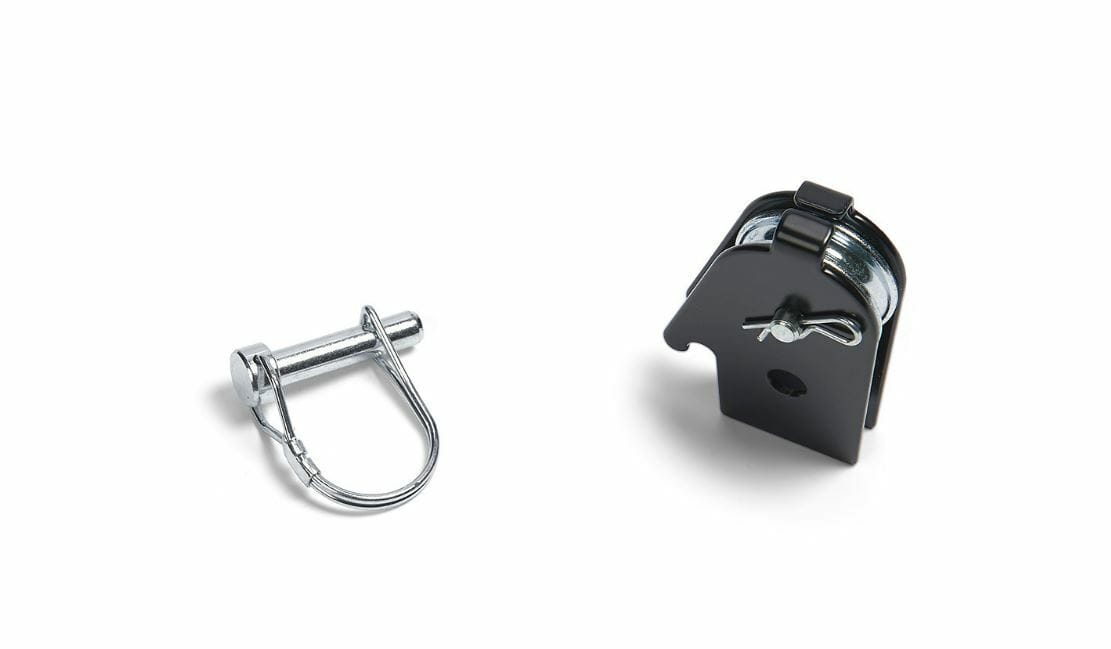 The Snow Plow Assembly Pulley By Warn features a metal shackle pin on the left and a black pulley block with an exposed metal wheel on the right, both displayed against a white background.