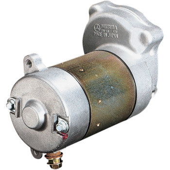 Silver and bronze cylindrical starter motor with mounting bracket and electrical terminals, compact metallic construction.