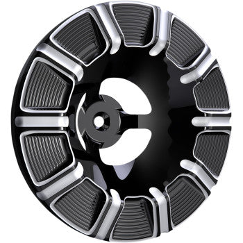 A glossy black and silver round wheel cover with eight textured sections and a decorative center, similar in style to the Arlen Ness Velocity Air Cleaner Cover - 10-Gauge - Black.
