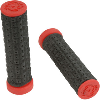The Torc1 ATV KTM Enduro Dual Grips in black/red feature textured handles with red end caps and a raised dot traction pattern for added grip and vibration-reducing comfort. Shown on a white background, one grip lies flat while the other is slightly angled.