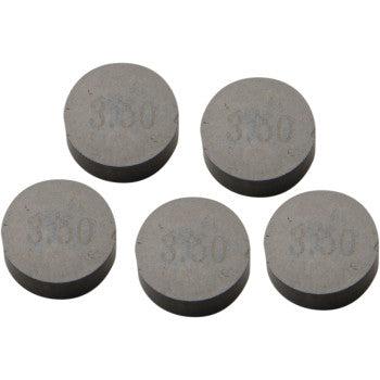 Five round gray metal valve shims, each stamped with "3.50" on the surface.