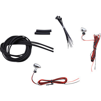 Pair of small chrome motorcycle turn signals with red lenses, black wiring, zip ties, and tubing accessories.