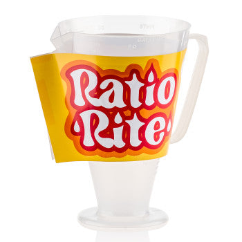 The Measuring Cup by Ratio Rite features bold red and white labeling on a yellow background, with a handle and spout—ideal for measuring fluids or mixing 2-cycle engine premix. Shown upright on a white surface.