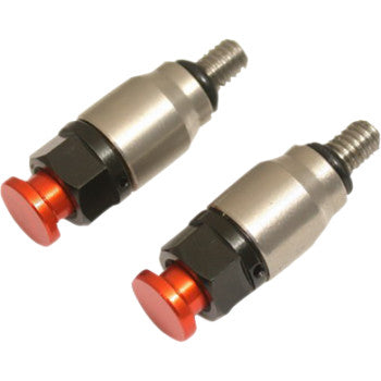 The Fork Air Bleeder Orange by TMV features two anodized orange units with red push buttons and threaded ends, displayed diagonally on a white background.