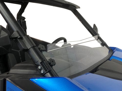 A close-up of a blue off-road vehicle with a partially open CFMOTO Z-Force 800/950 Short Hard Coated Windshield by Spike, highlighting the steering wheel and roll bars for added protection and visibility.